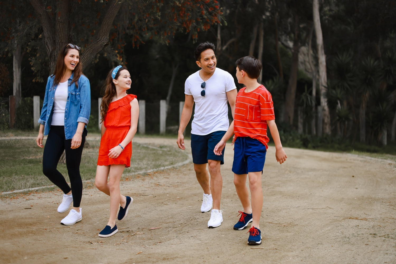Mom and Dad walking with two kids while grounding