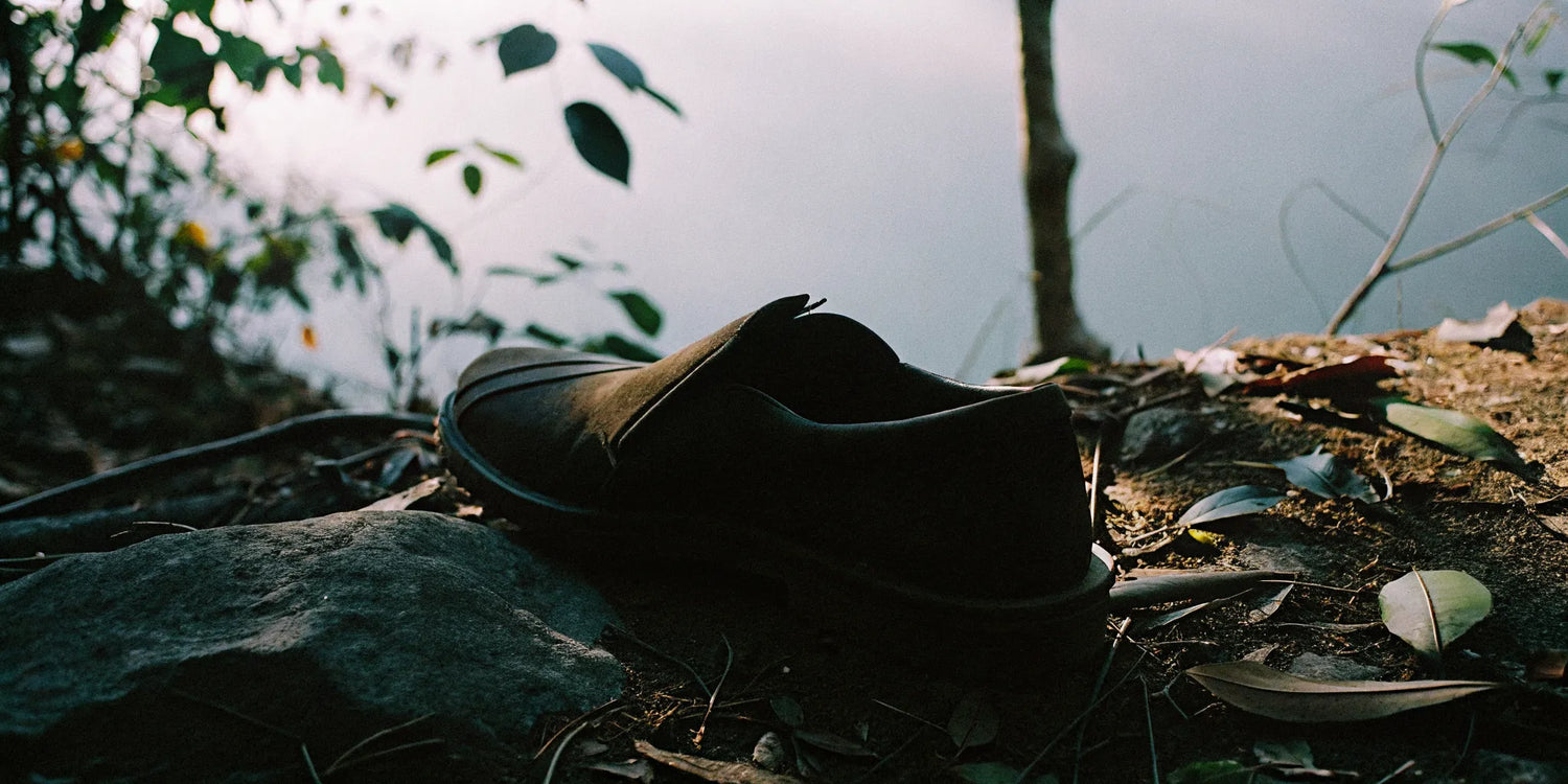 Elegant grounding shoe on natural earth surface representing wellness and arthritis joint pain relief through earthing