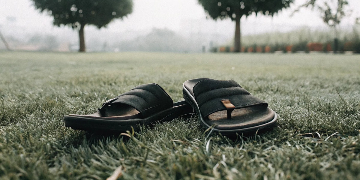 A pair of grounding shoes on grass for workout recovery