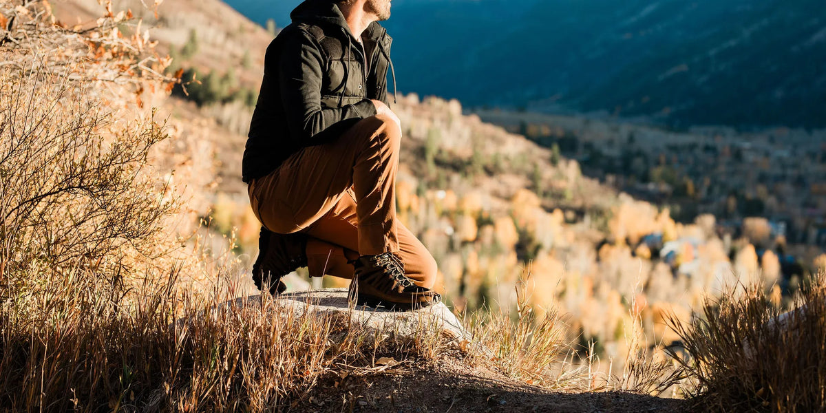 A person wearing grounding loafers while walking outdoors on a natural path