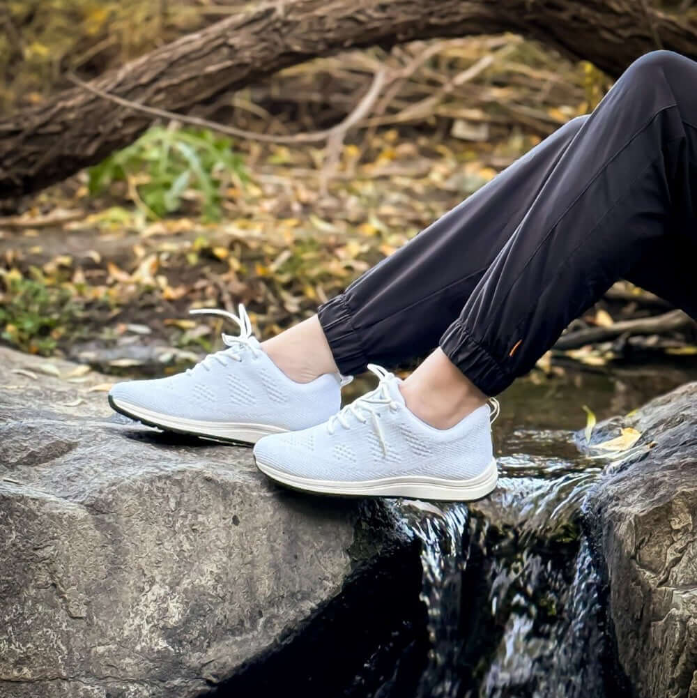 Woman wearing Alex white recycled plastic earthing grounding sneakers
