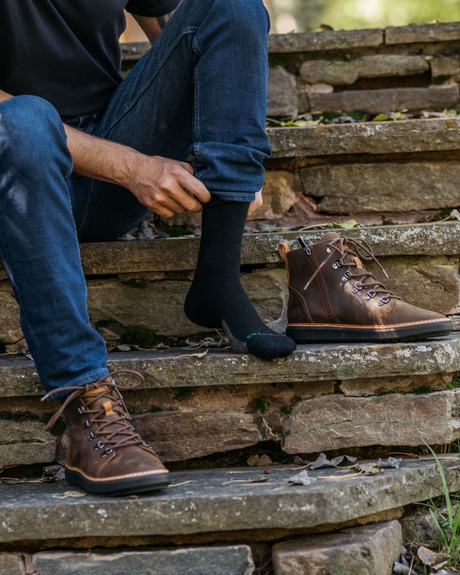 Close up Of man Sitting on stone Steps wearing Harmony 783 Crew Style Grounding Socks Black Merino Wool with Silver Stitching conductive earthing socks
Lifestyle1