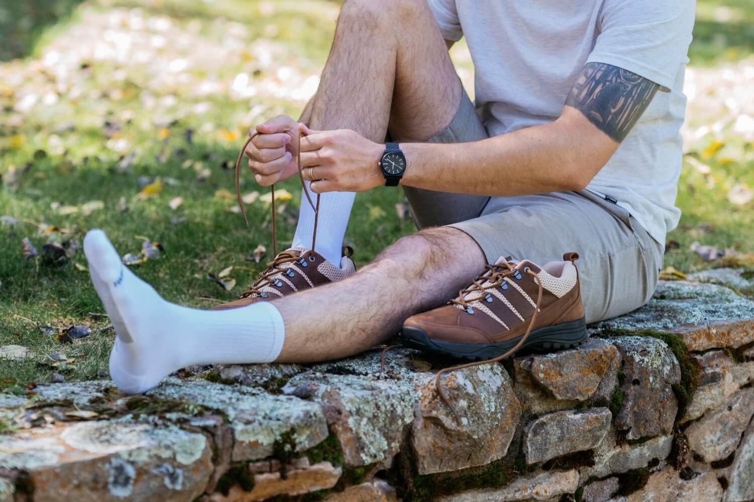 Close up Of man Sitting on stone ledge wearing Harmony 783 Crew Style Grounding Socks White Organic Cotton with Silver Stitching conductive earthing socks
Lifestyle2