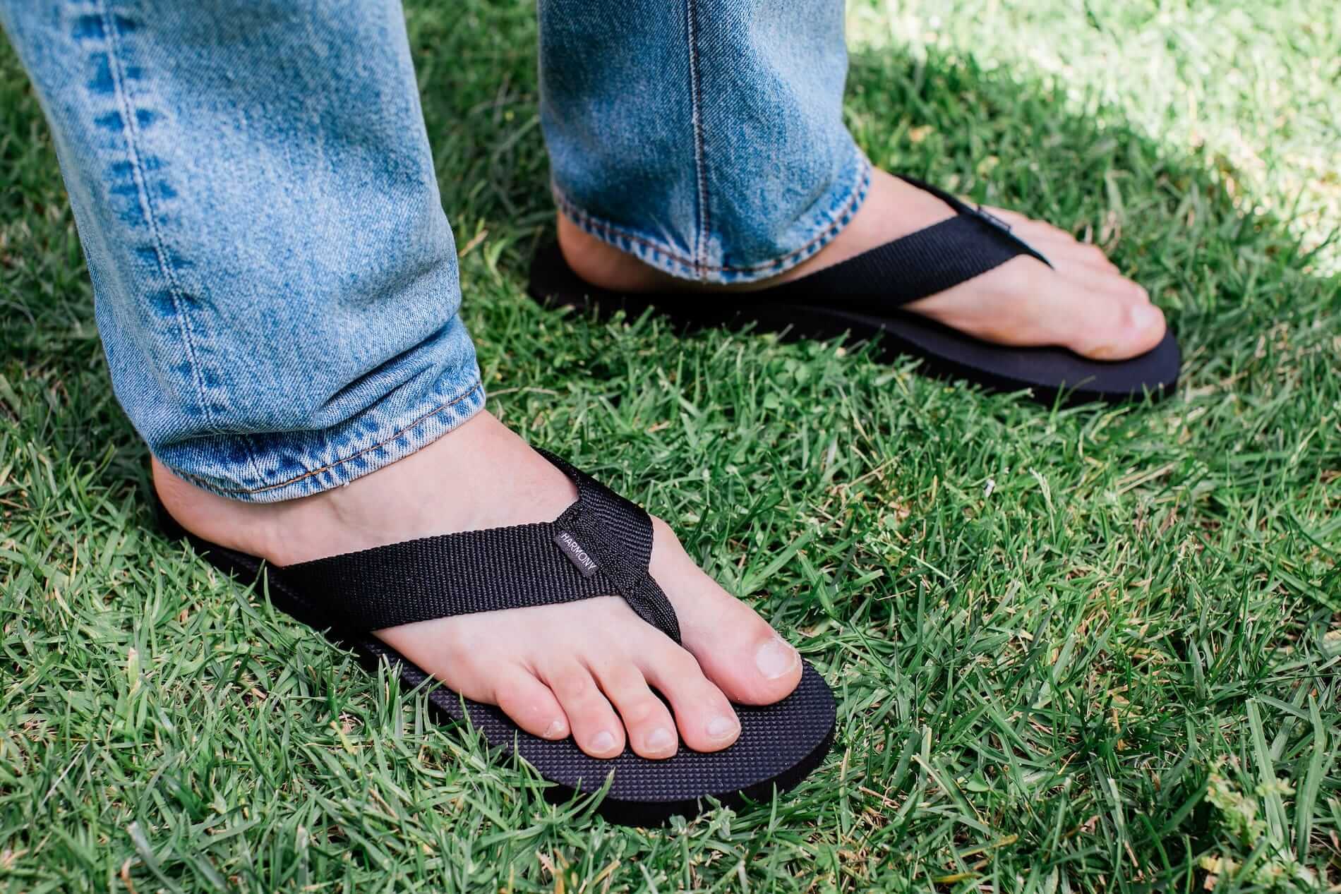 close up of man standing on grass wearing Harmony 783 Men’s Flip Flop Black sandal conductive
footbed earthing