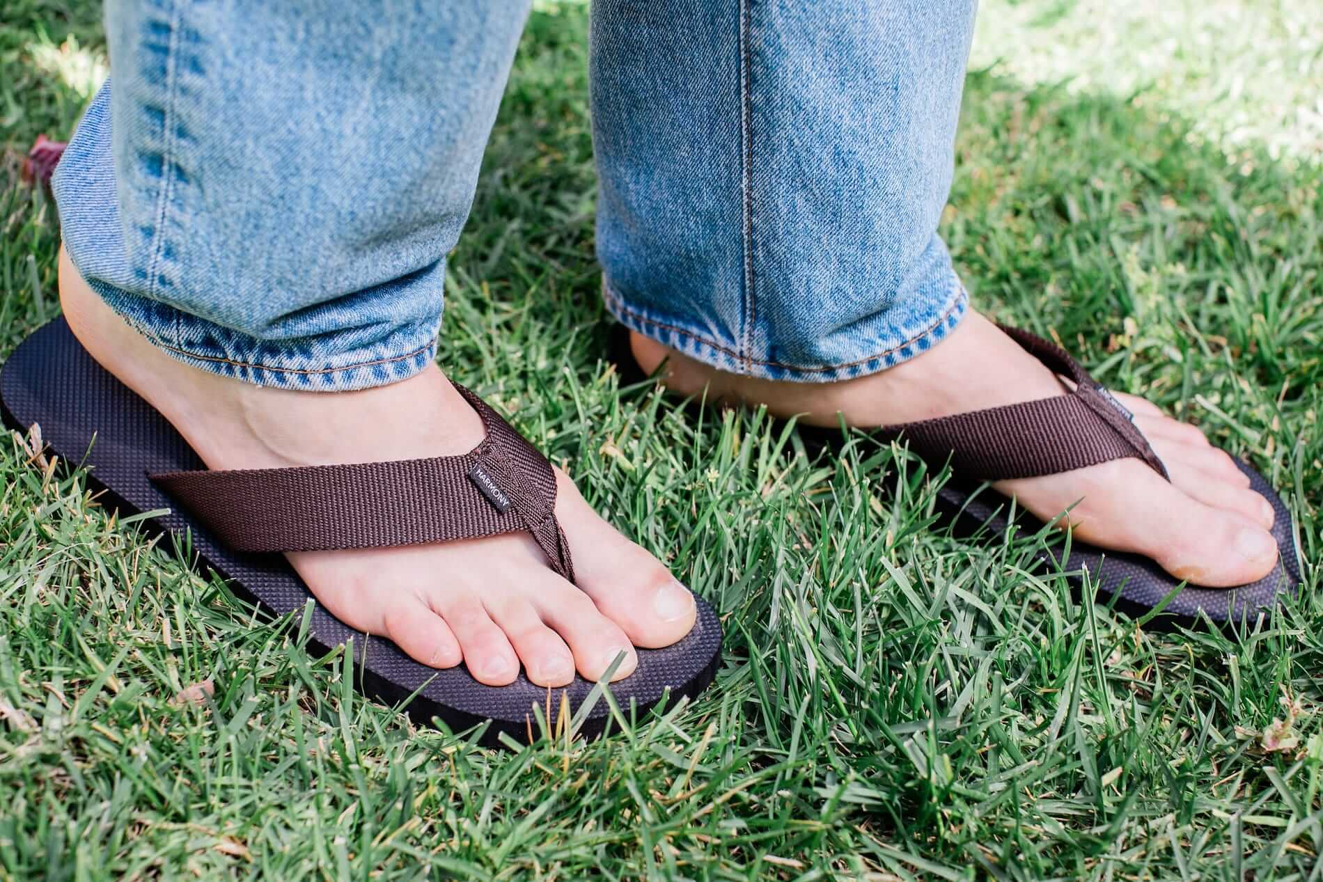 Close up of man standing on grass wearing Harmony 783 Men’s Flip Flop Brown sandal conductive
footbed earthing