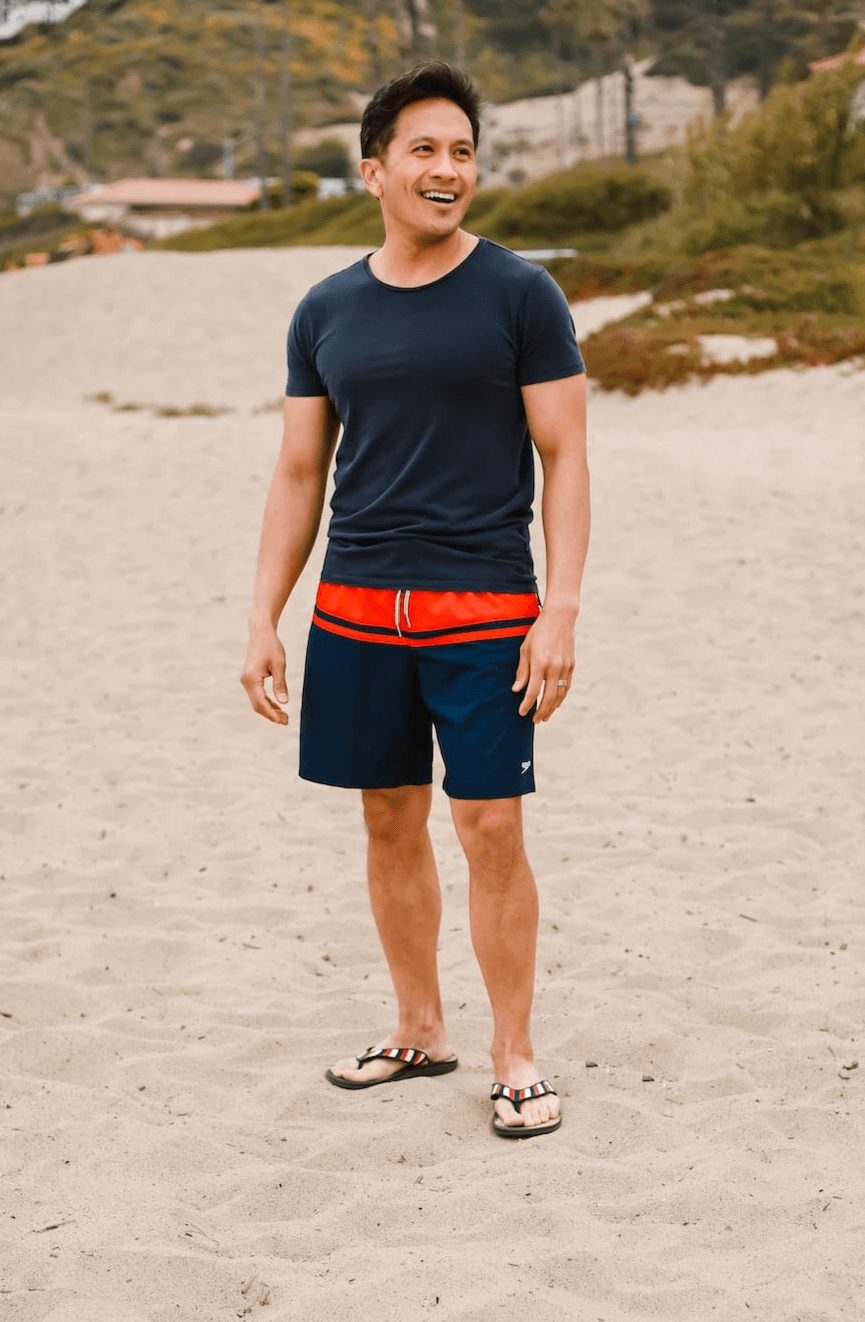 man standing on sand at the beach wearing Harmony 783 tatum red white and blue striped sandal conductive
footbed earthing
