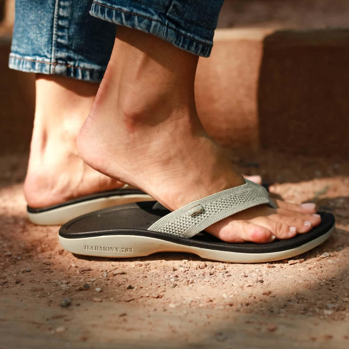 Close up of standing on dirt wearing Harmony 783 tatum platinum knit sandal conductive
footbed earthing