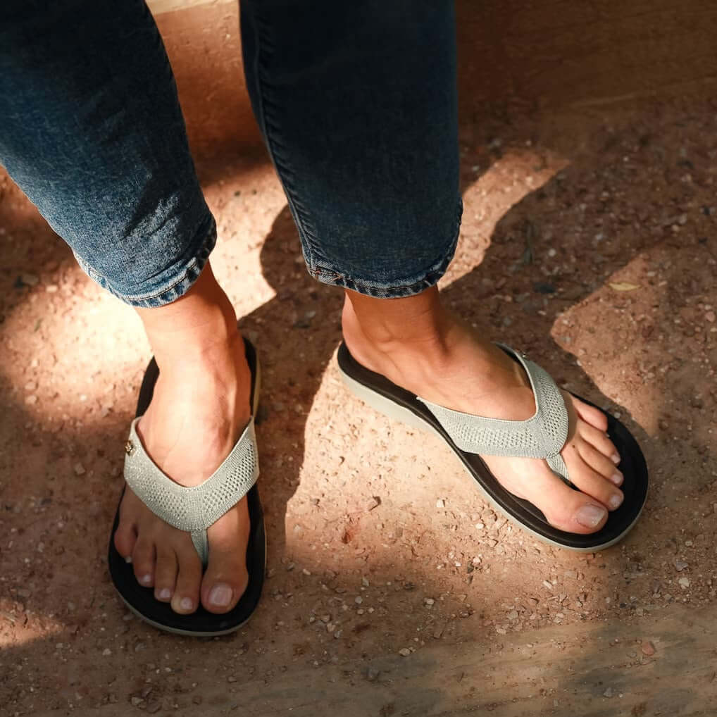 Close up of man standing on gravel stairs wearing Harmony 783 tatum platinum knit sandal conductive
footbed earthing
