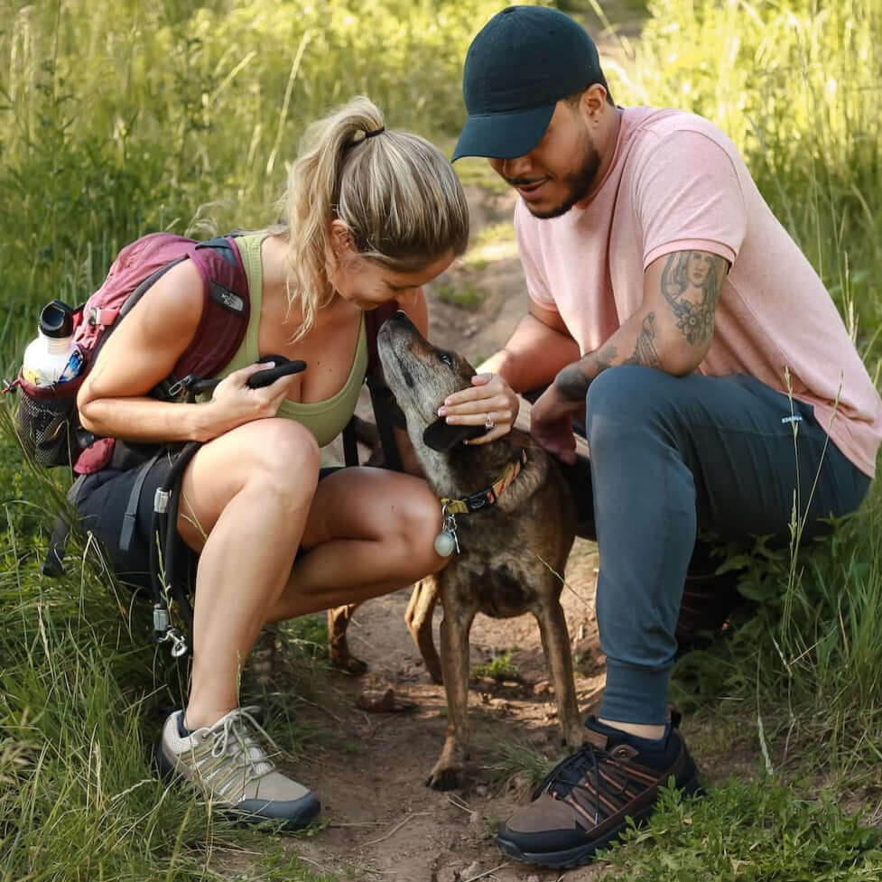 Man and woman hiking with a dog and woman wearing Dakota Trail Shoe Khaki and Creme for grounding and earthing