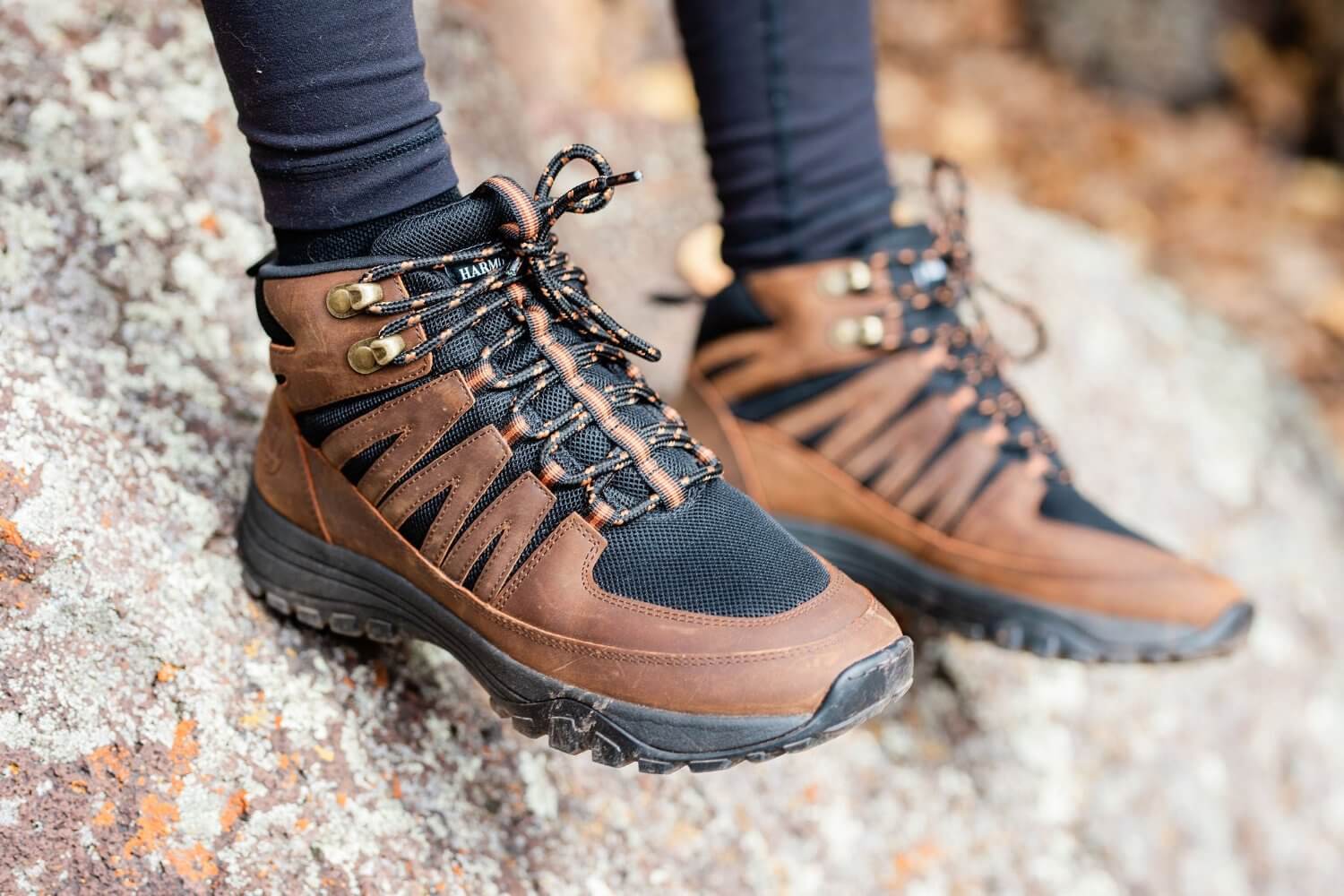 Woman wearing High Top Trail Shoe for Grounding Brown leather Black Mesh on Rock