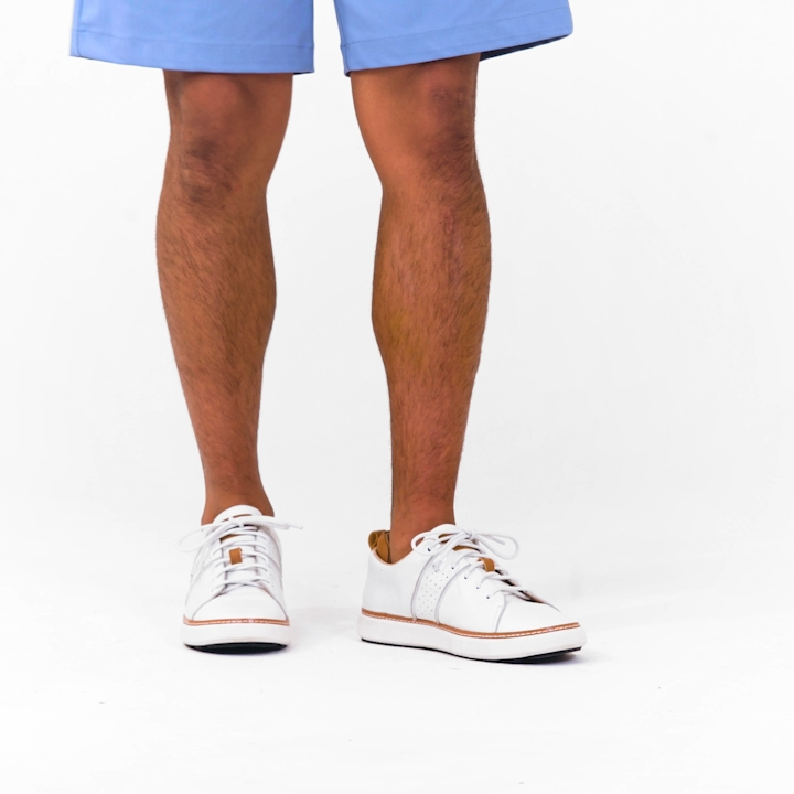 man walking in white leather walking shoes for grounding