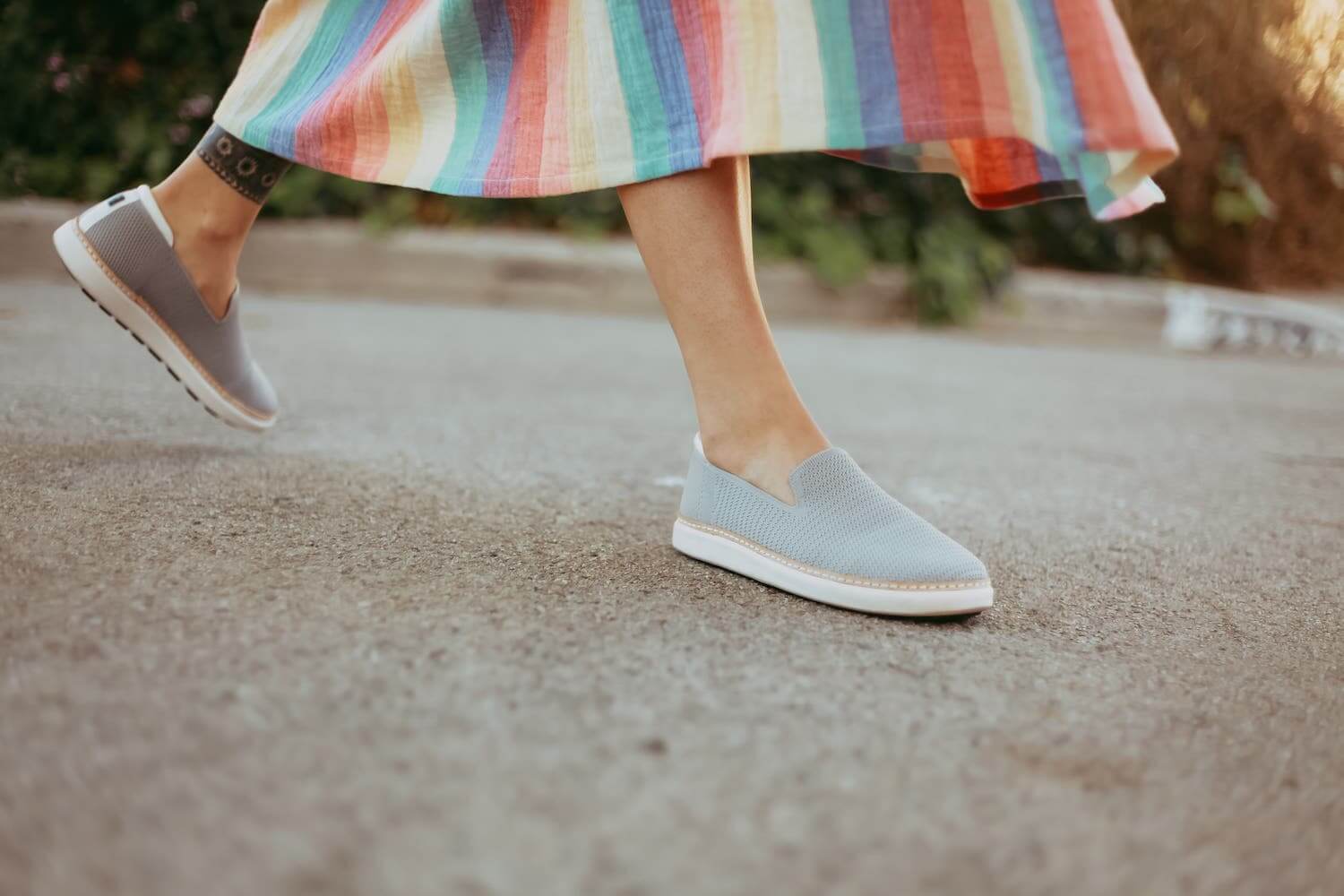 Woman wearing colorful skirt walking in grey knit grounding bamboo slip-ons