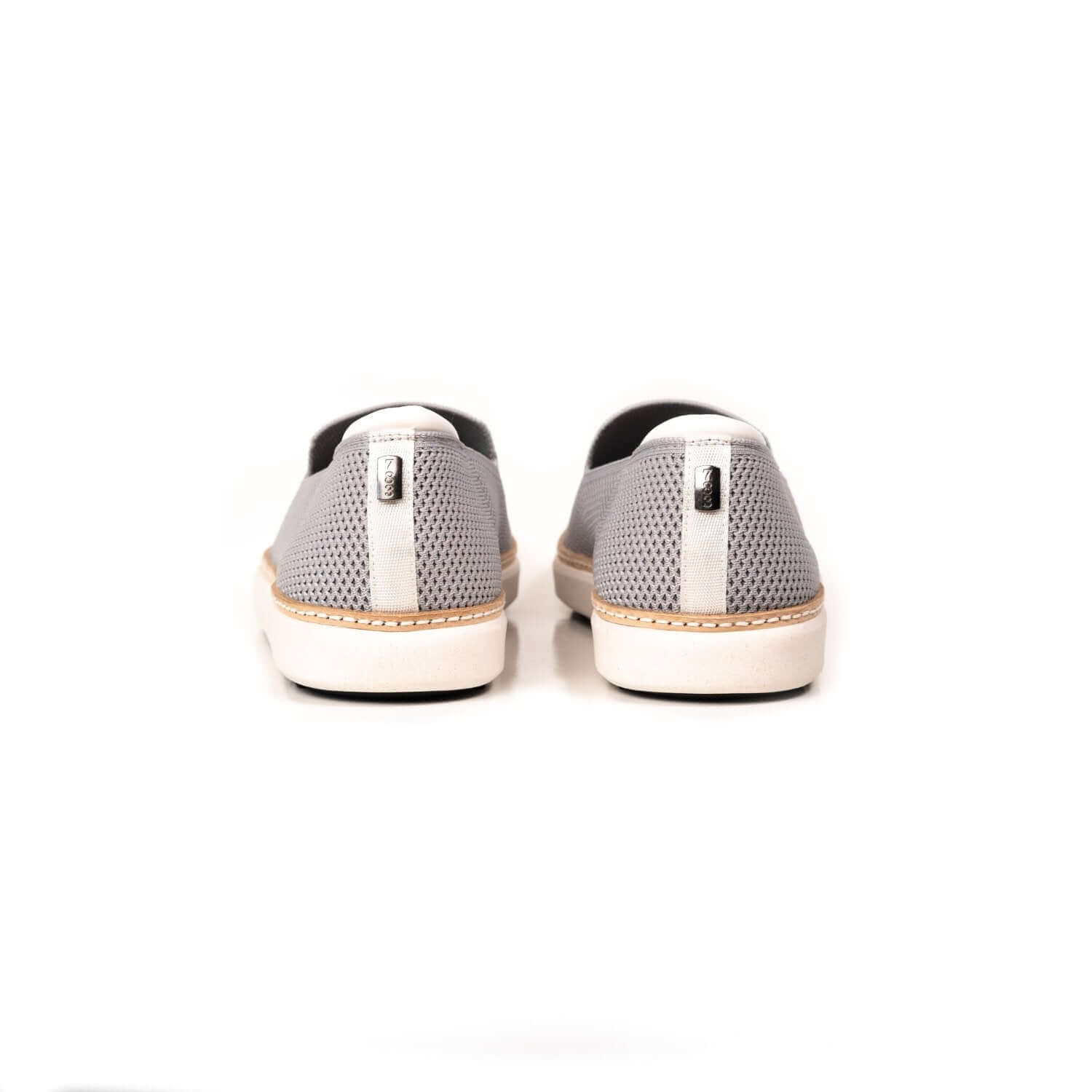 Heel view of white trim on grey bamboo knit grounding slip ons