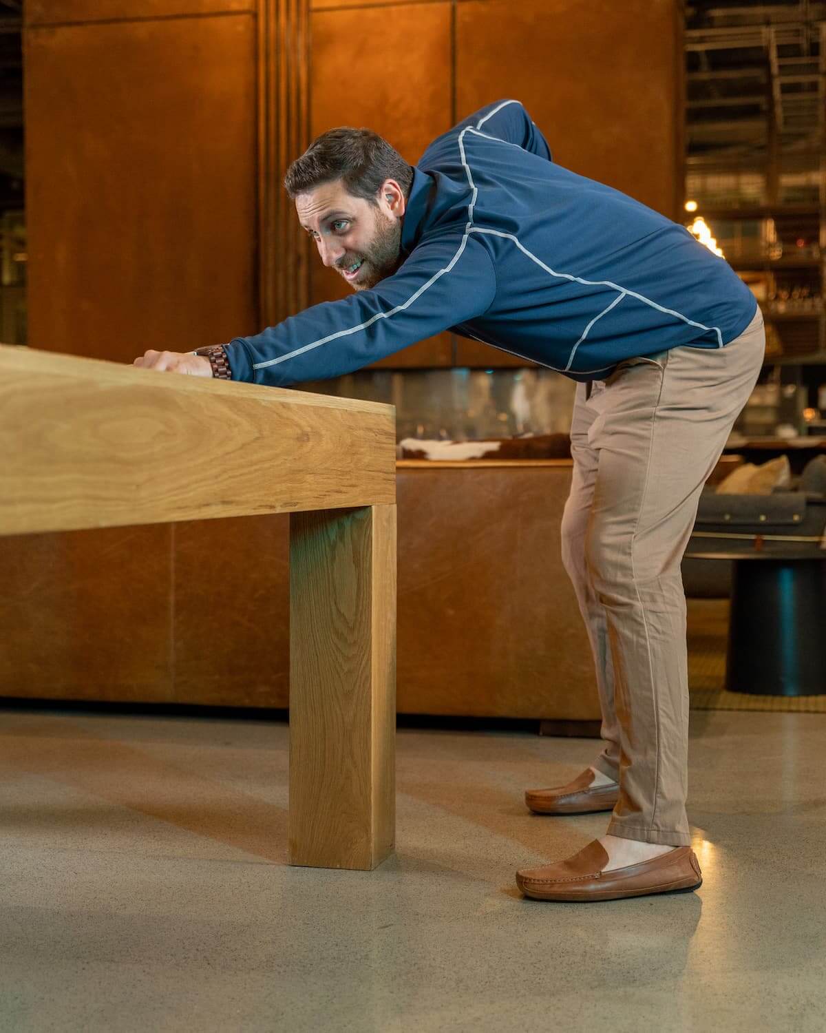 Man wearing brown leather driver for grounding while playing pool