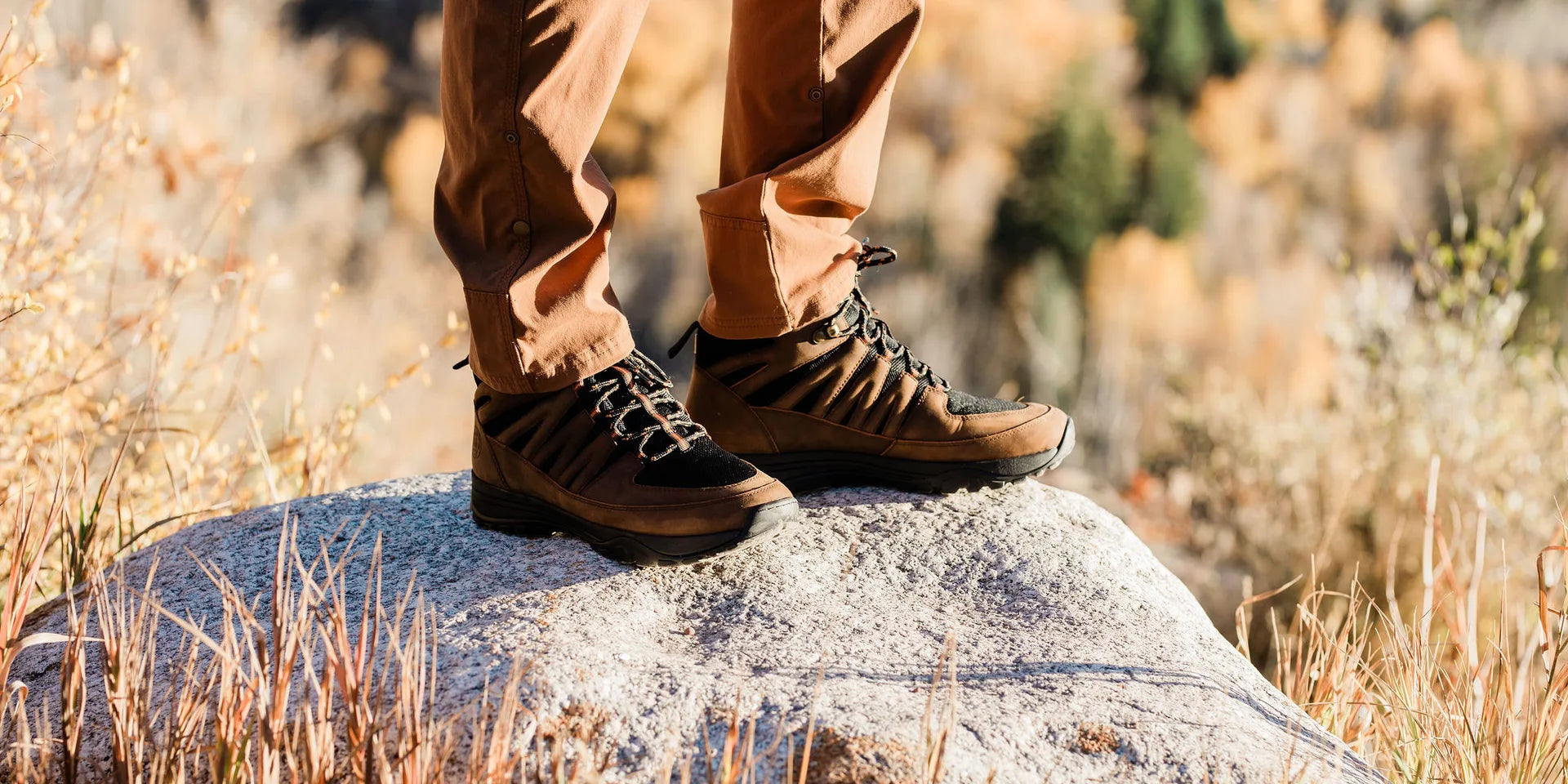 A person outdoors wearing grounding footwear in a calm natural setting