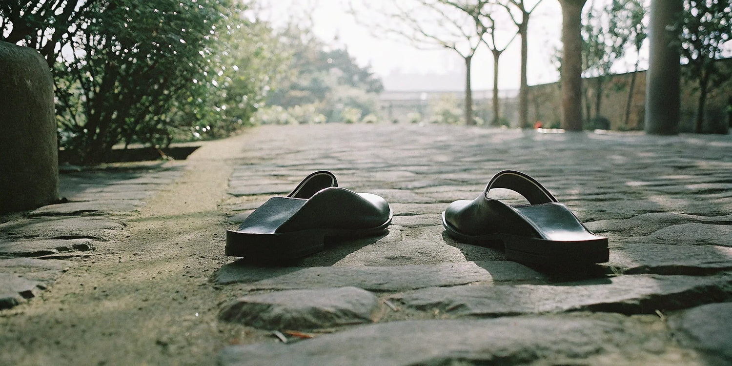 Minimalist grounding slip-on shoes on a natural stone path