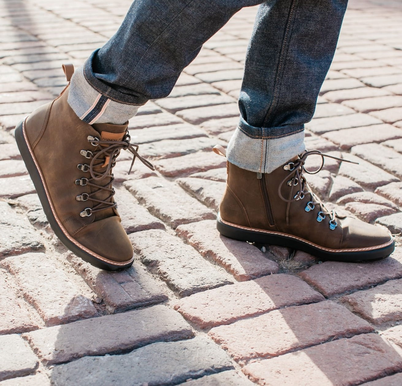 Man wearing zip up brown leather high top boots with jeans