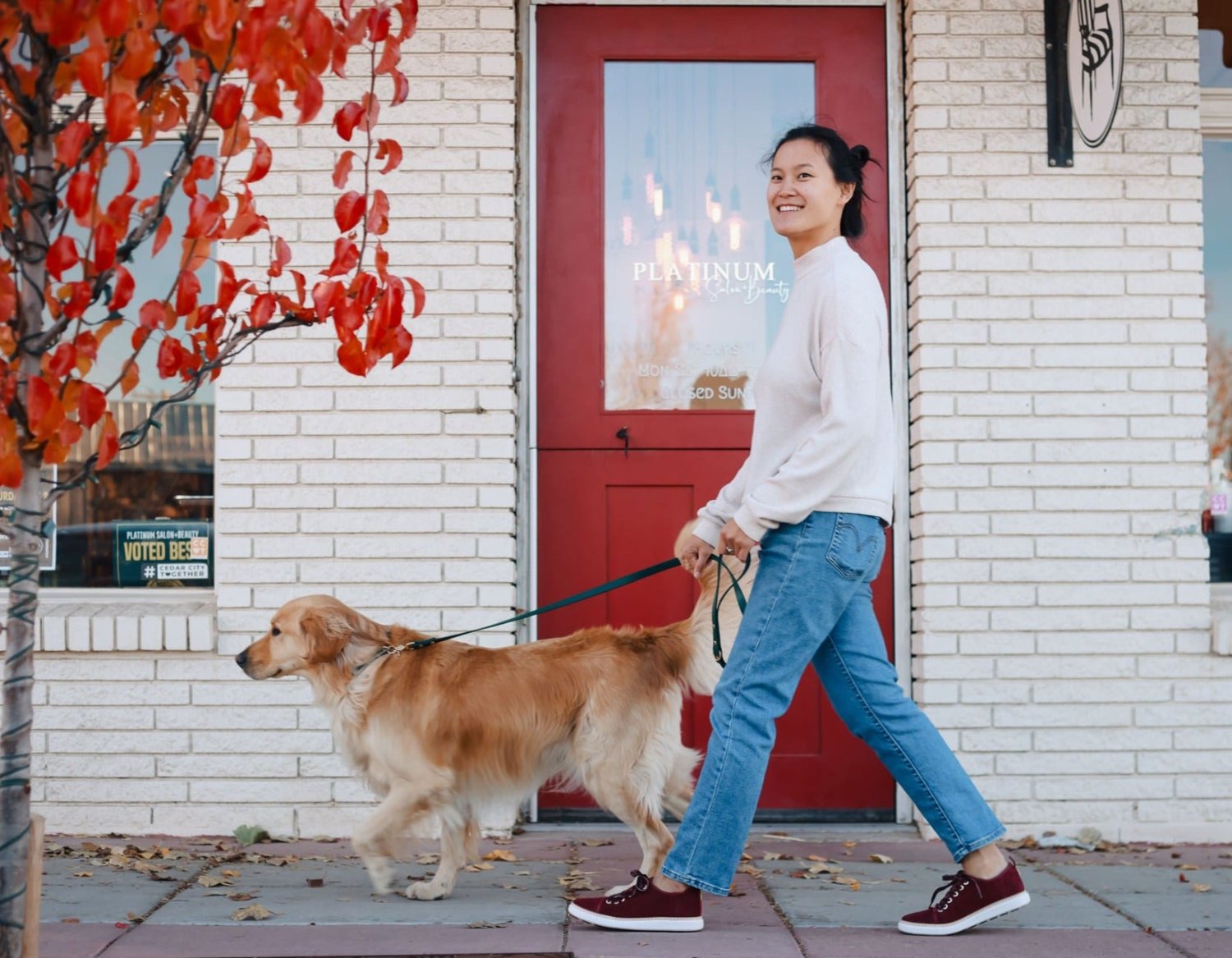 Woman walking her dog in fall wearing cabernet suede walkers