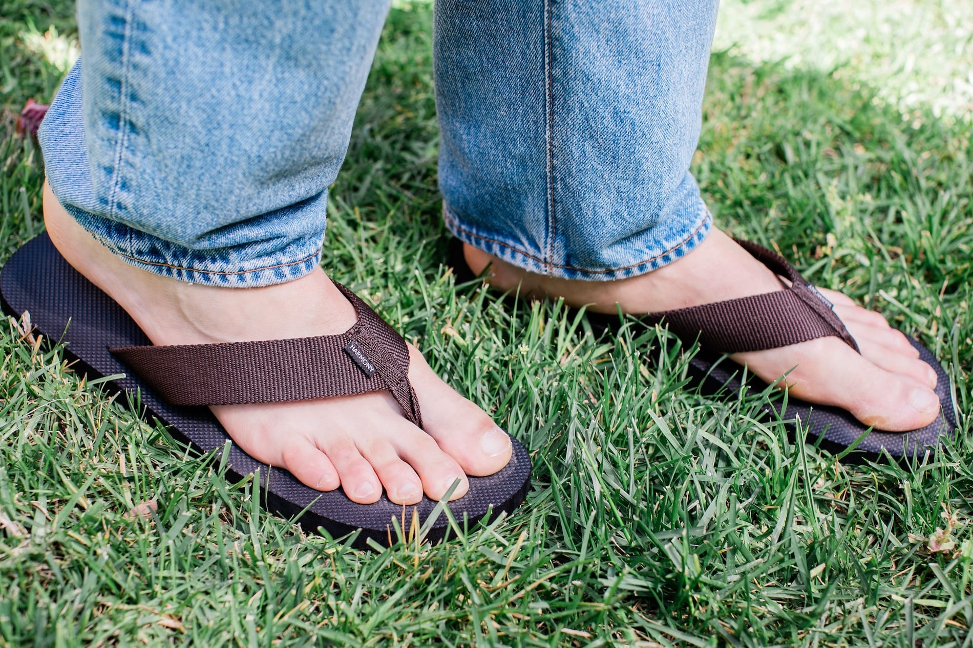 Close up of man standing on grass wearing Harmony 783 Men’s Flip Flop Brown sandal conductive
footbed earthing 