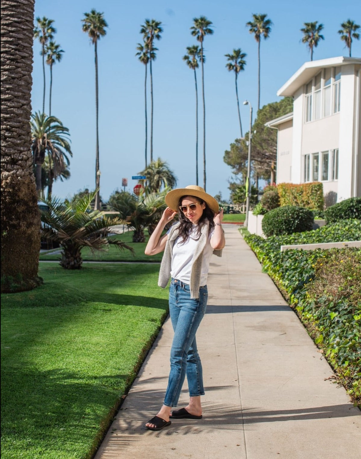 woman with hat walking on sidewalk wearing Harmony 783 sophie slide knit black sandal  conductive
footbed earthing 
