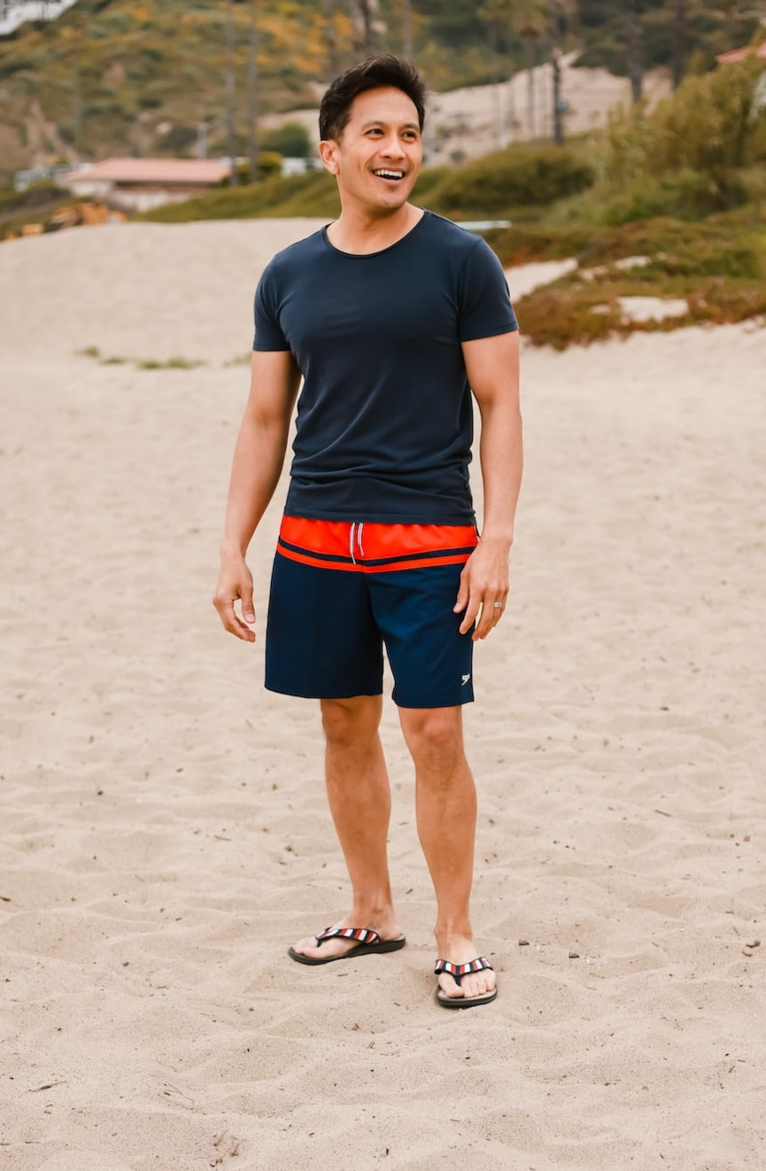 man standing on sand at the beach wearing Harmony 783  tatum red white and blue striped sandal conductive
footbed earthing 