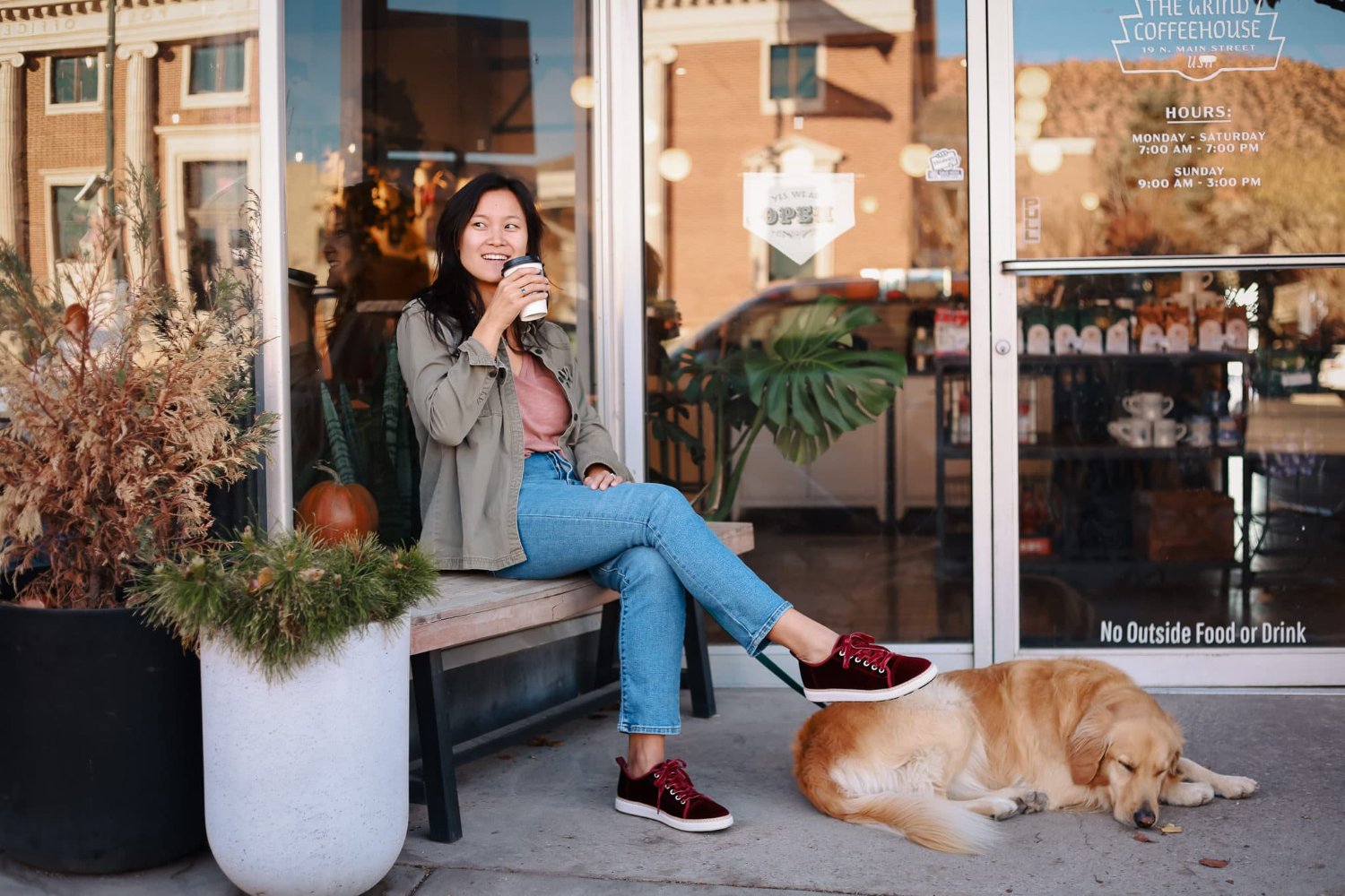 Women sitting outside coffee shop with her dog wearing charlotte bordeaux red velvet grounding walkers