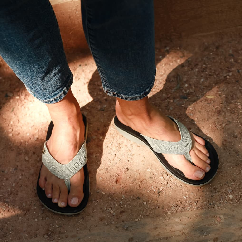 Close up of man standing on gravel stairs wearing Harmony 783  tatum platinum knit sandal conductive
footbed earthing 