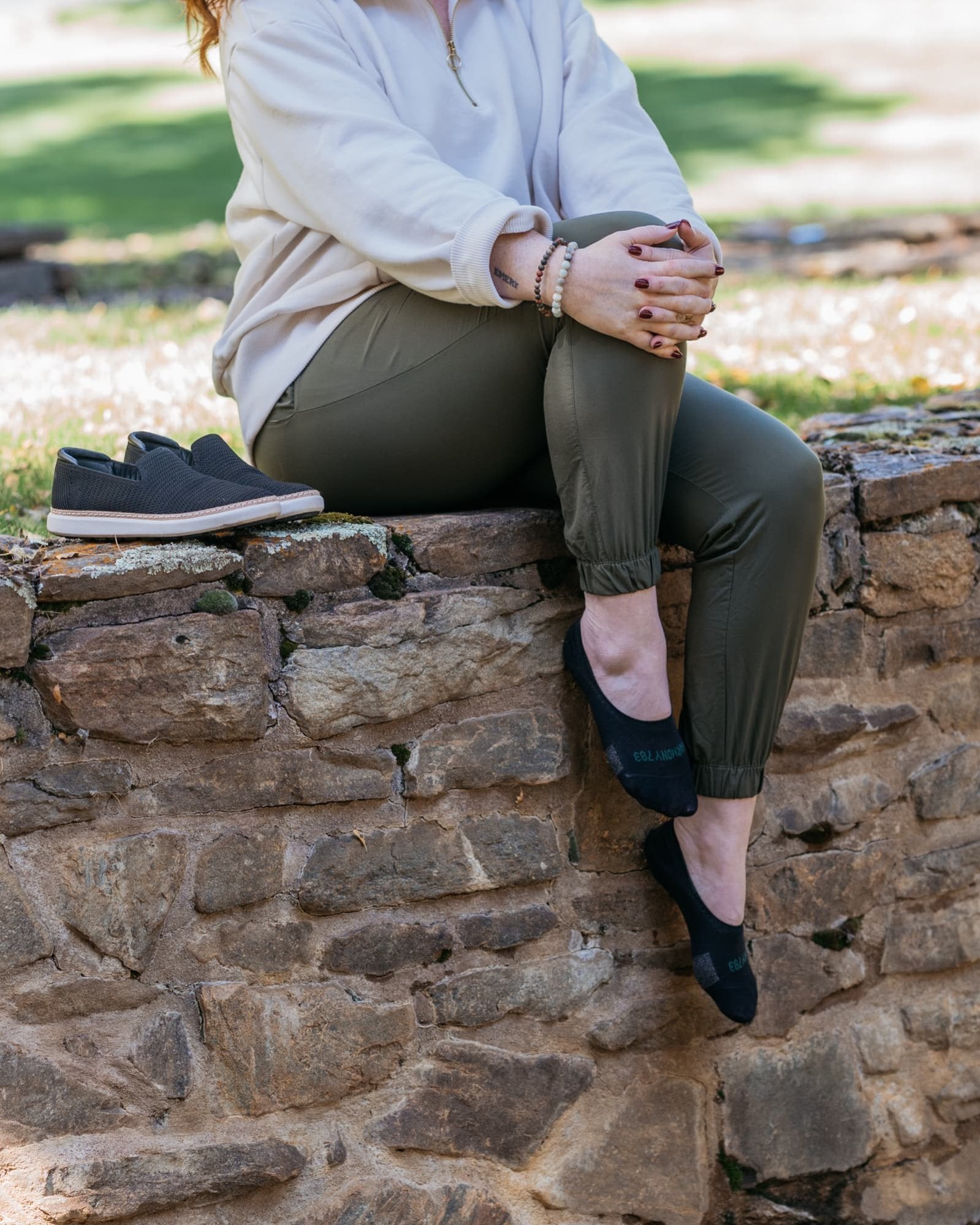 
Close up of woman sitting on stone ledge wearing Harmony 783 No Show black Grounding earthing socks Organic Cotton
Lifestyle 3