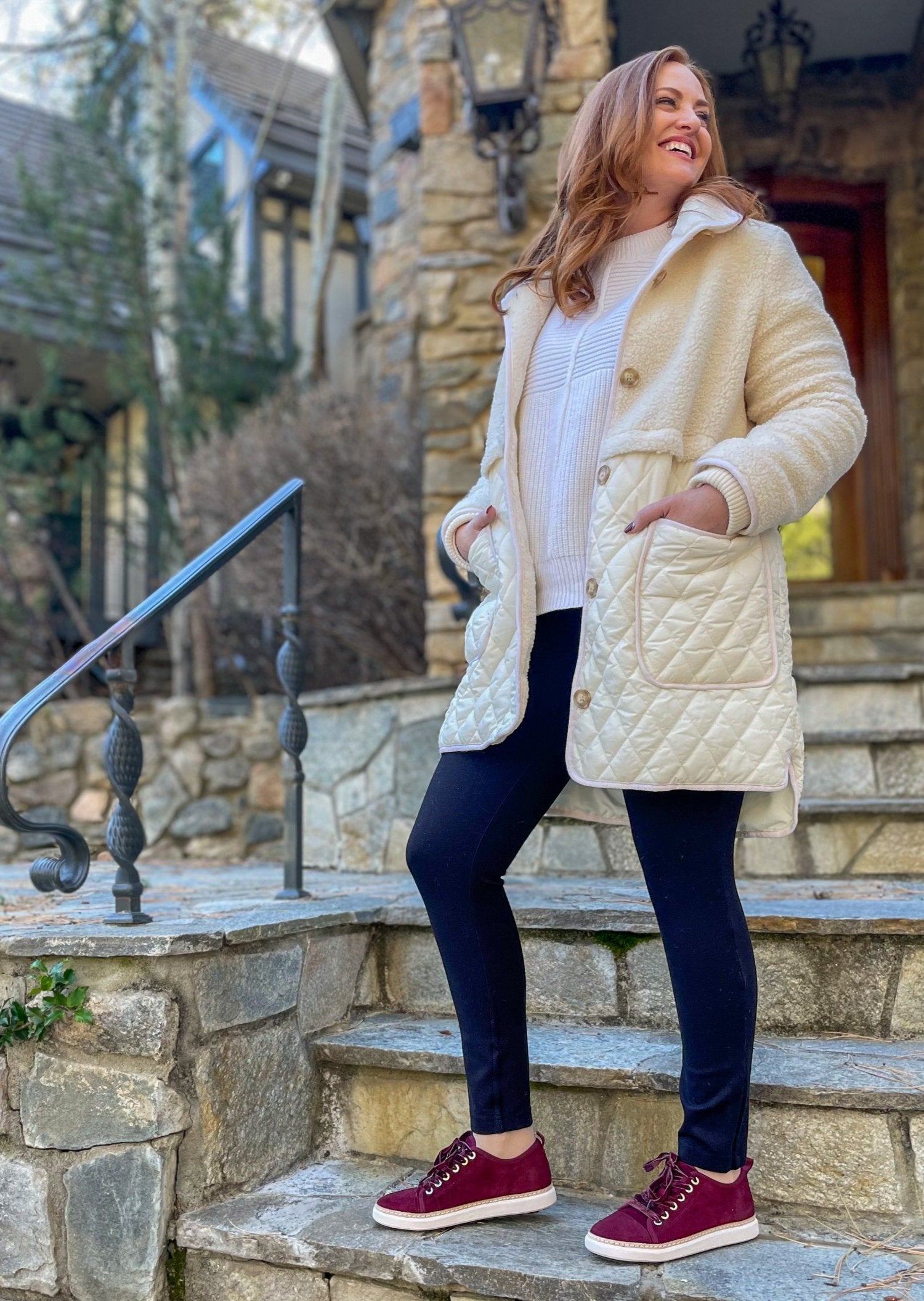 woman standing on stone wearing cabernet suede grounded walkers in winter