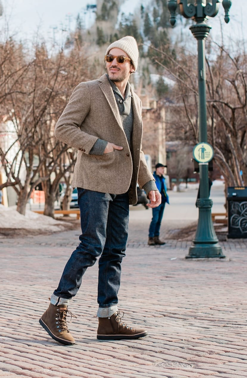 Man wearing brown leather grounding high top boot on brick in winter