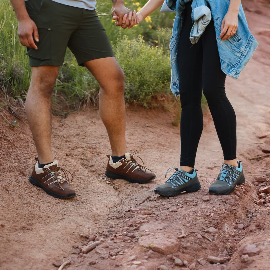 Man and woman hiking in summer while wearing grounding and earthing trail shoes designed by Harmony 783