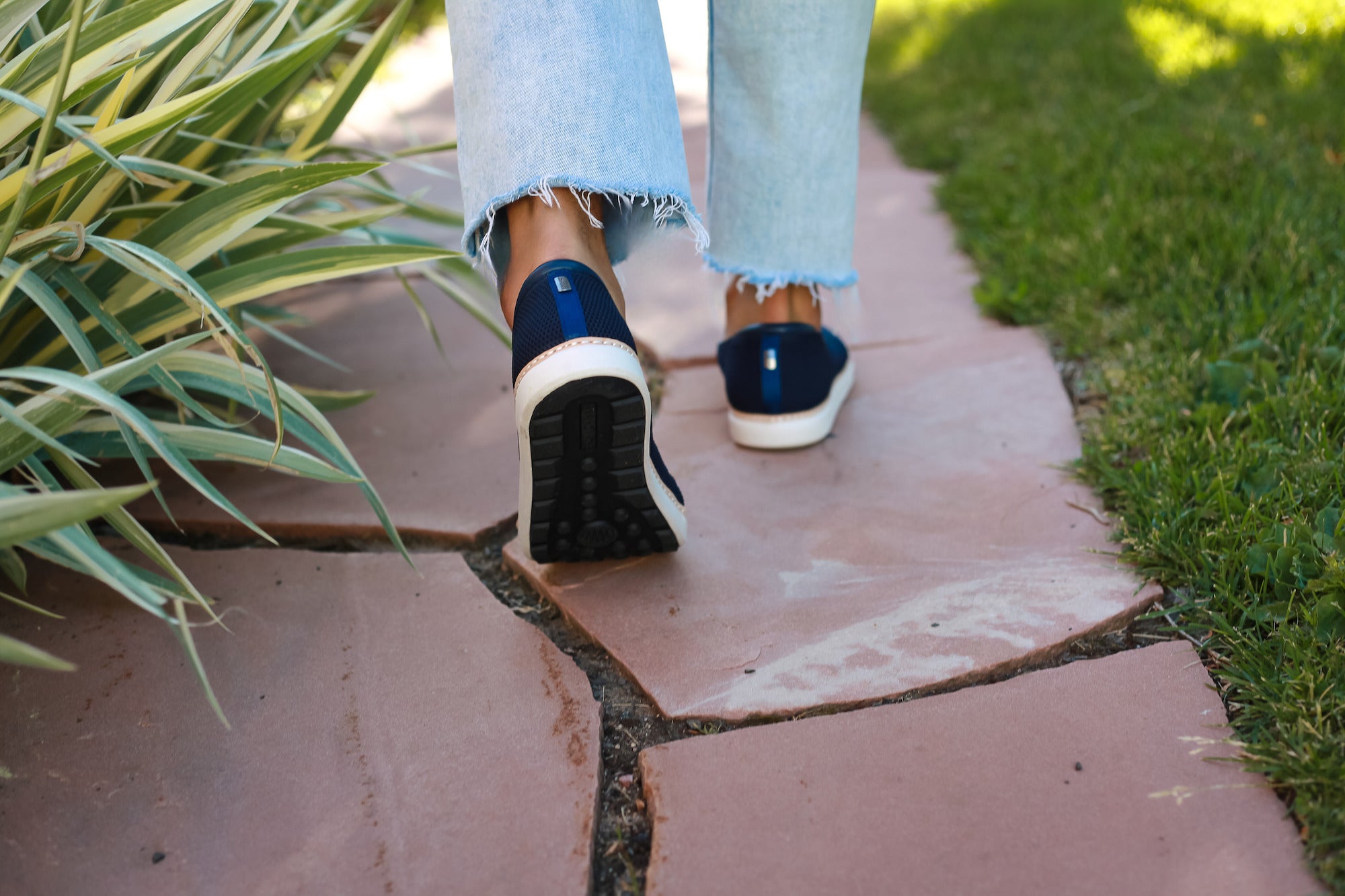 man walking on grounded surface in navy bamboo grounding slip-ons