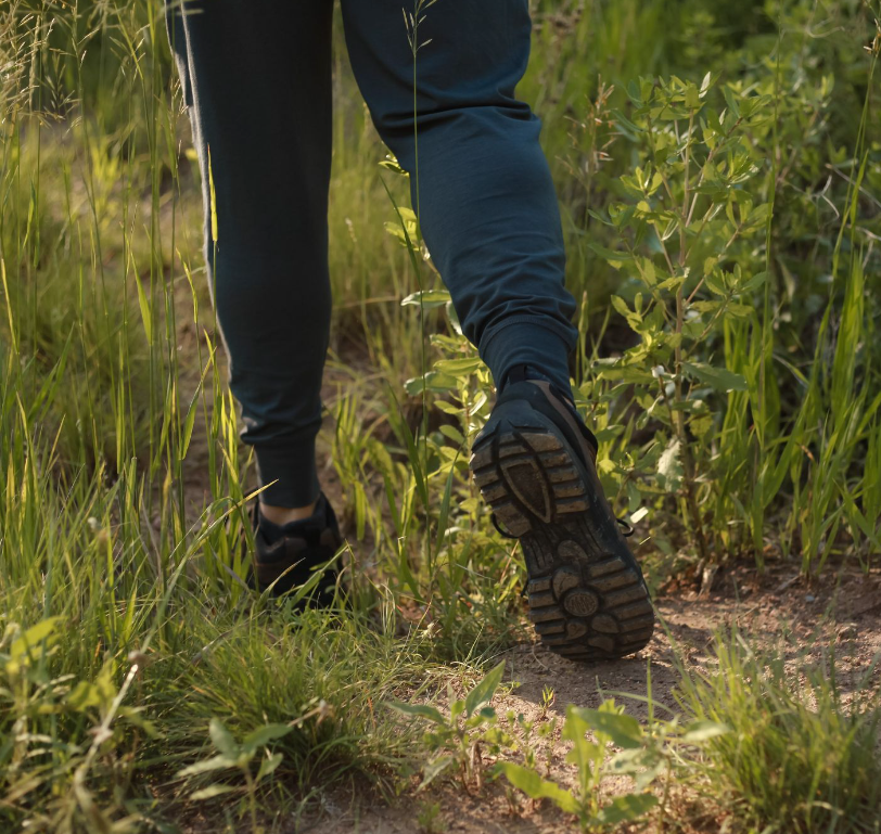 man hiking showing tread of grounded trail shoe