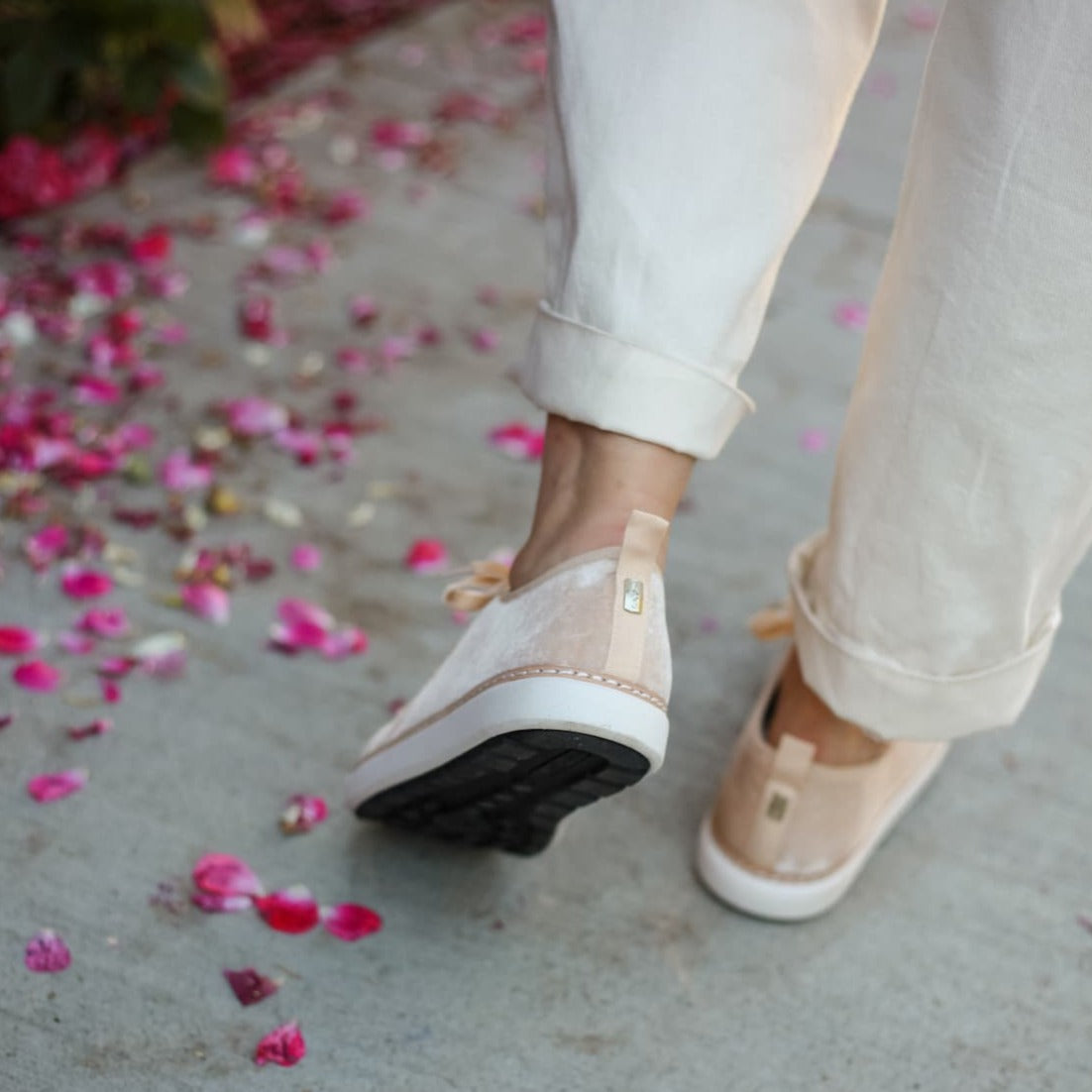 Woman walking away showing sole and heel of grounding champagne velvet walker