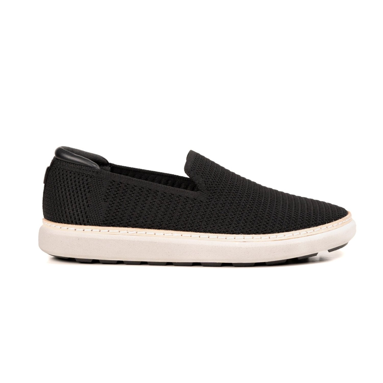 Profile view of black and white grounding slip-ons for men and women