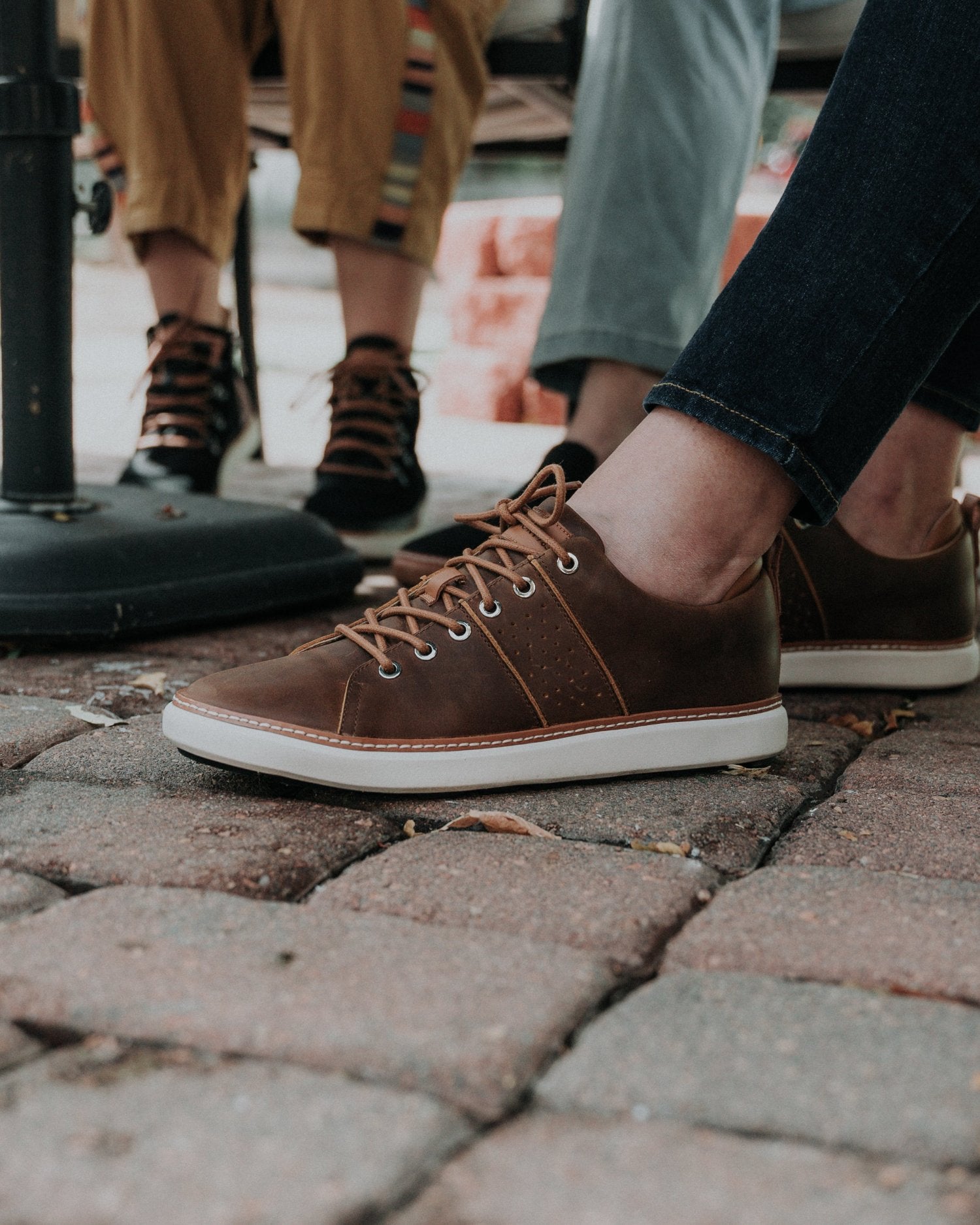 Brown leather walking shoe for grounding on brick surface