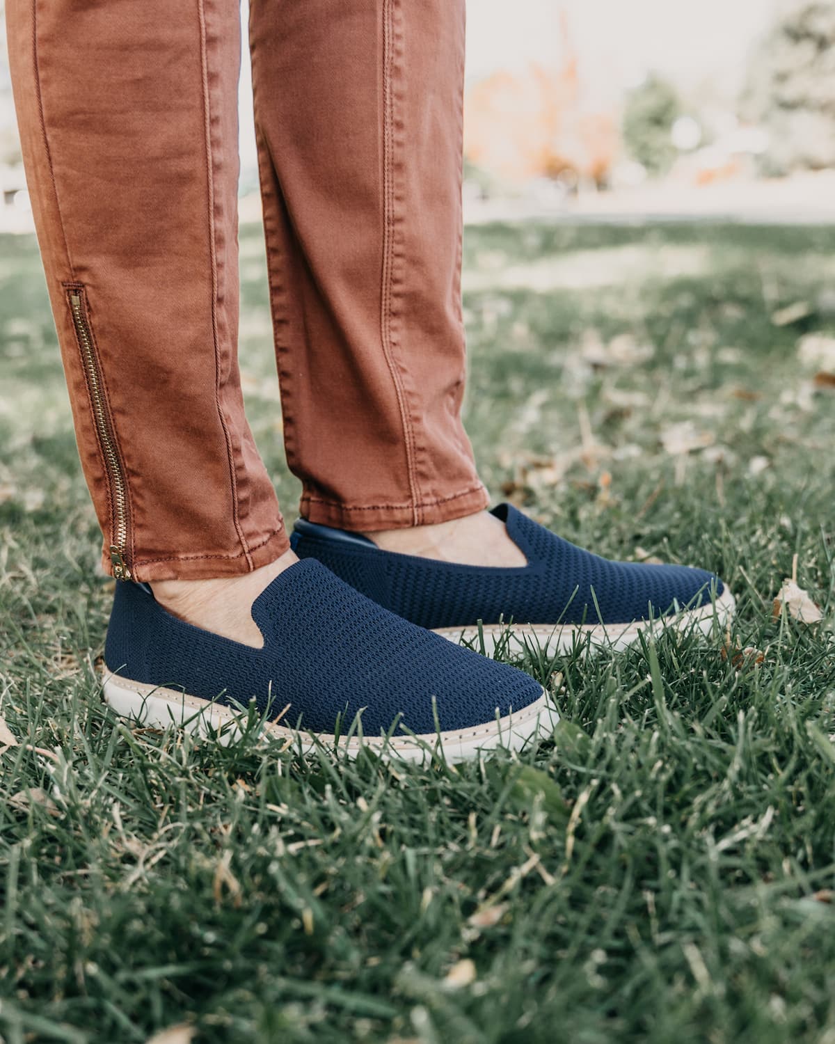 Woman wearing unisex bamboo knit slip-on for grounding and earthing in Navy